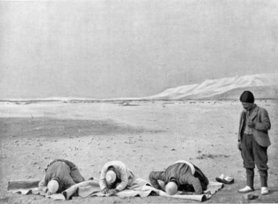 Camel Men saying their Prayers at Sunset. Camel Men saying their Prayers at Sunset.