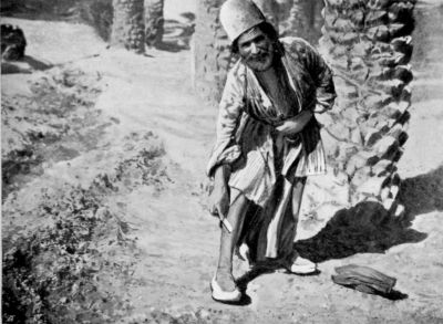 Naiband Barber Stropping a Razor on his Leg. Naiband Barber Stropping a Razor on his Leg.