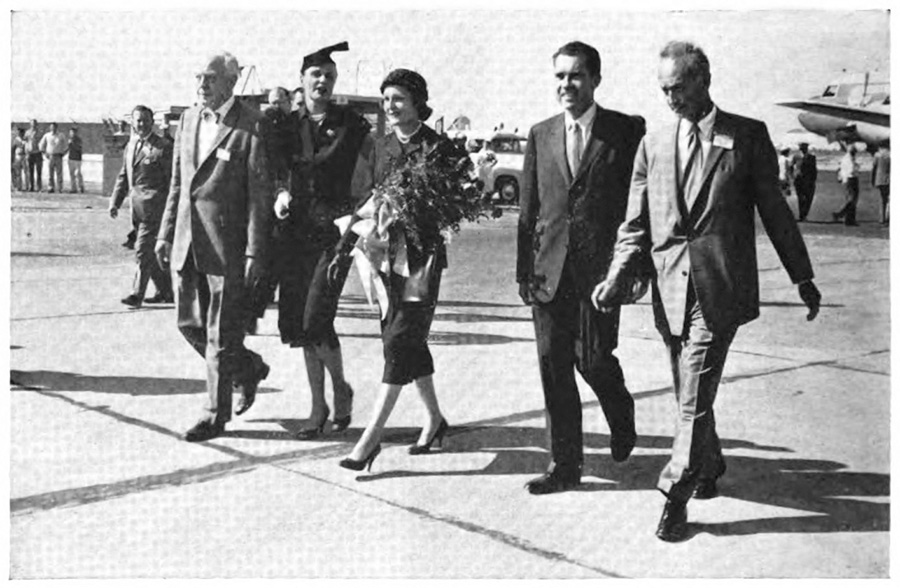 Picture of five men and women in business attire walking