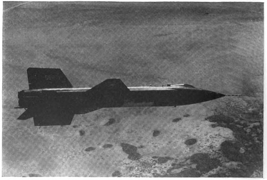 A plane in the air over what seems to be a coastline with a number of small islands