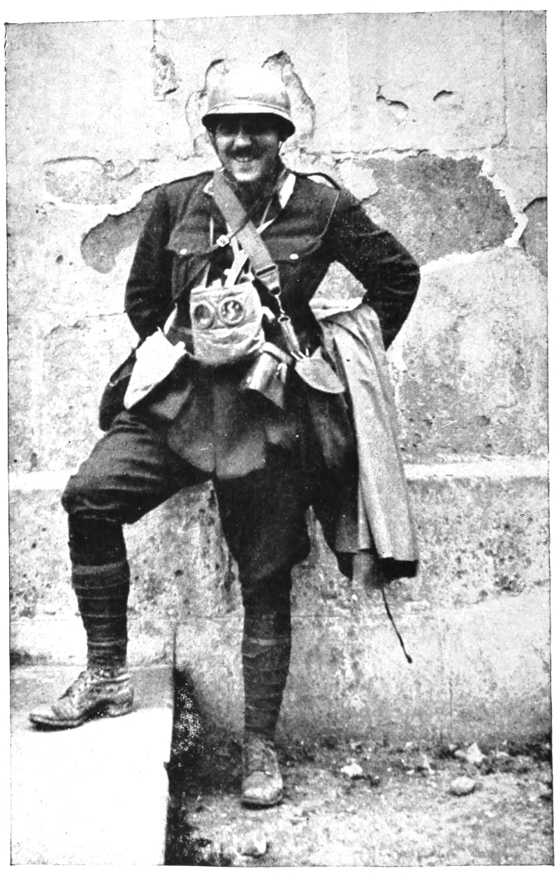 A man in uniform smiling with one leg propped on some stairs.