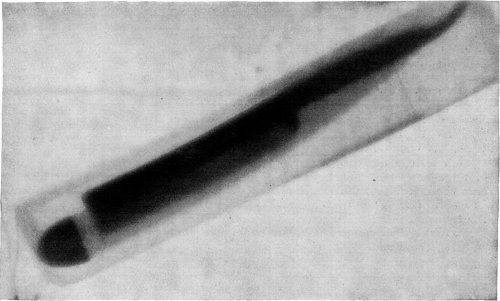 RAZOR-BLADE PHOTOGRAPHED THROUGH A LEATHER CASE AND THE RAZOR-HANDLE.