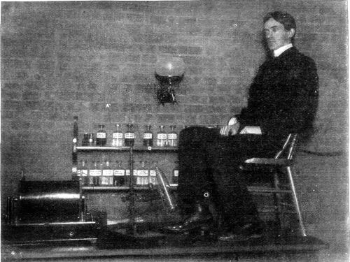 PHOTOGRAPHING A FOOT IN ITS SHOE BY THE RÖNTGEN PROCESS.—A PICTURE OF THE ACTUAL OPERATION WHICH PRODUCED THE PHOTOGRAPH SHOWN ON PAGE 408.