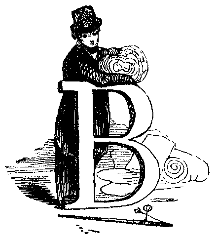 A woman leans against a letter B.