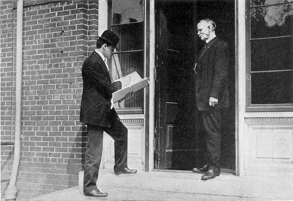 TAKING THE CENSUS IN A CITY. Enumerator at a doorway, entering in his portfolio the details of a household.
