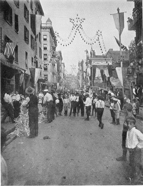 FESTA IN THE ITALIAN QUARTER. Boys in Little Italy, New York, preparing for one of the many characteristic holidays. (Brown Bros.)