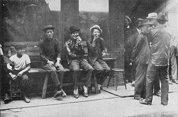 THE FIGHTING MEN OF THE TONGS. The younger combatants of the Five Brothers outside the impregnably guarded headquarters in Chinatown, New York.