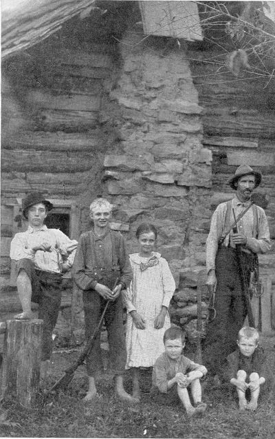KENTUCKY MOUNTAINEER FAMILY. In the heart of the feud district, where the rifle is never out of reach. (Courtesy of the Spirit of Missions.)