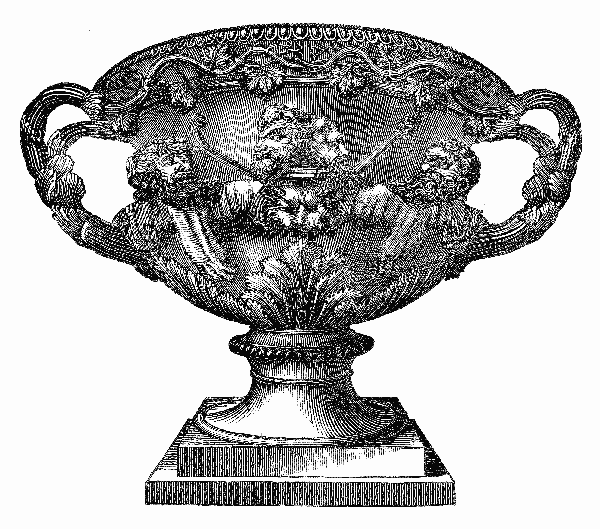 A large, wide vase with two handles and a number of sculpted heads.