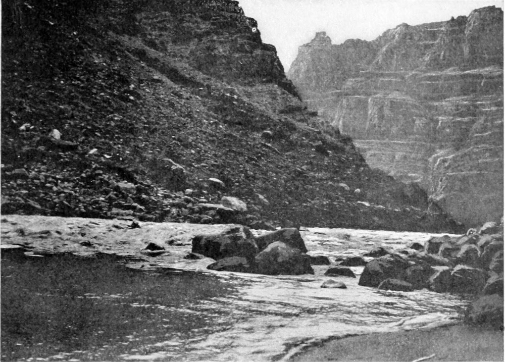 The river churns over boulders mid-stream. Emery in the 'Edith' is a small figure amid the moving water.