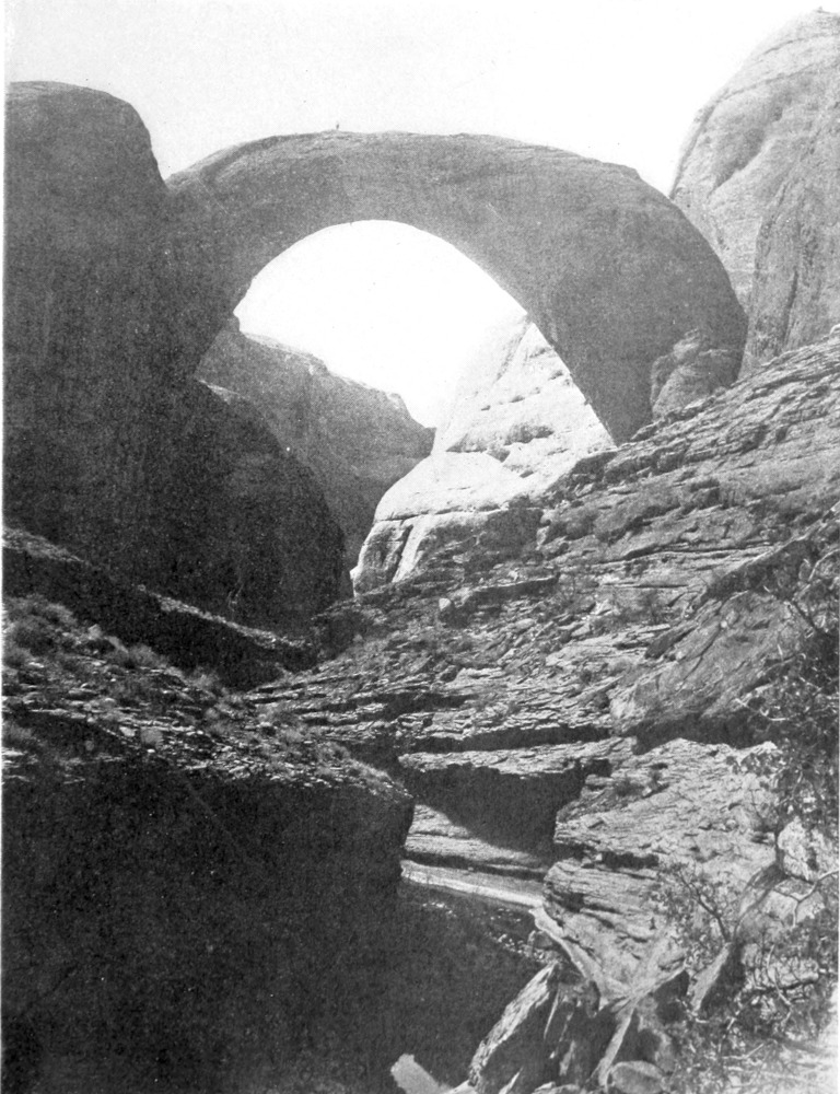 A tiny figure of a man is outlined at the top of the arch.