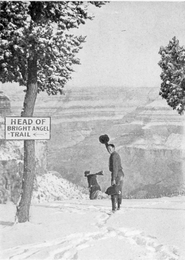 A tree bearing the sign 'Head of Bright Angel Trail' is on the left. Two men are heading through ankle-deep snow towards the canyon. One lifts his hat to wave good-bye.