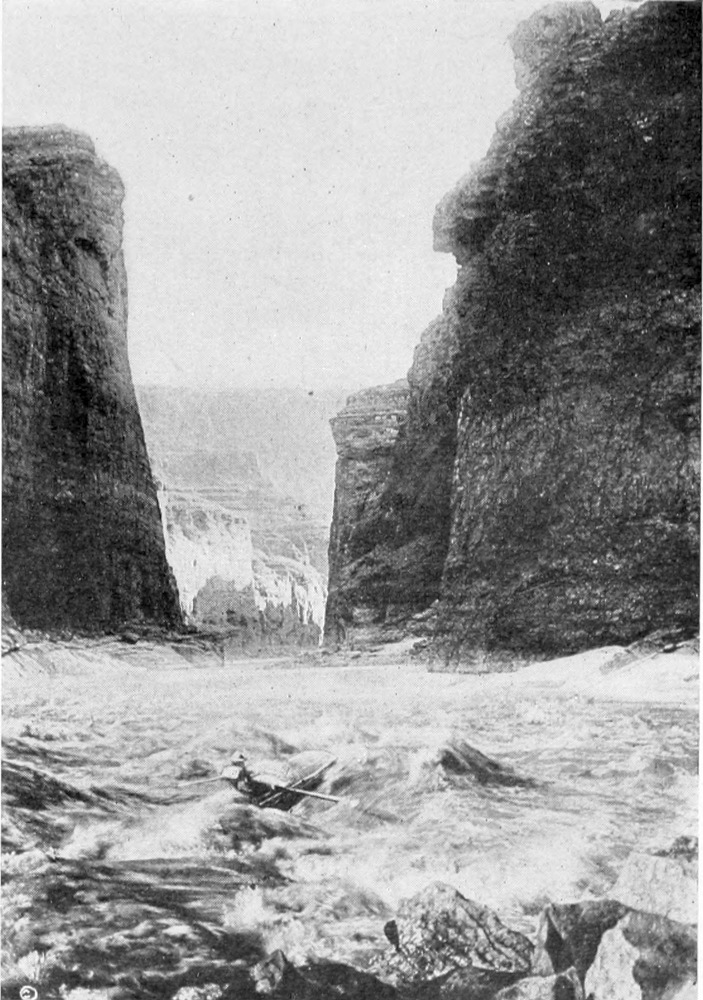 Turbulent water flows between two canyon walls.