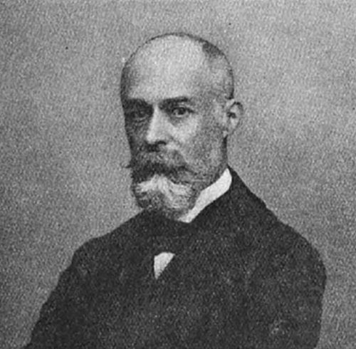 A photograph of a bald man with a prominent moustache and goatee in late 19th-century dress — consistent with portraits of Henri Becquerel, discoverer of radioactivity in 1896.